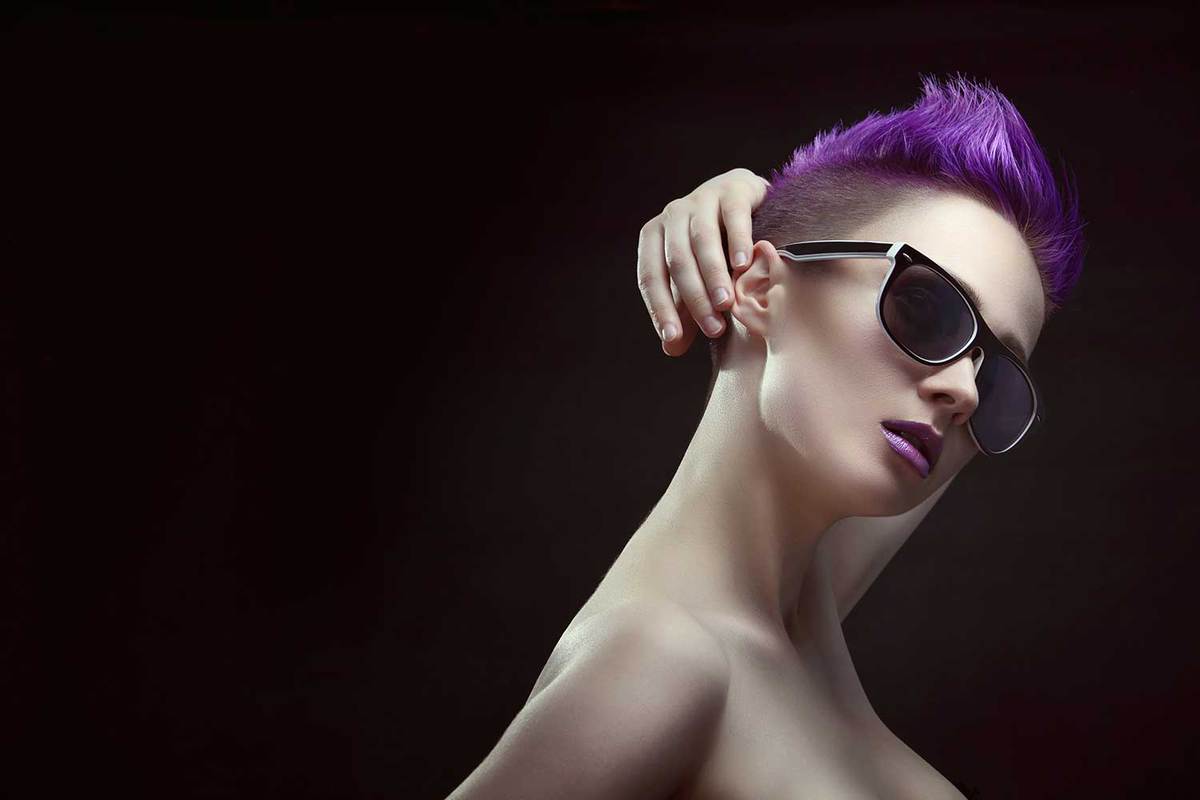 Beautiful young stylish girl with purple short hair in large stylish sunglasses