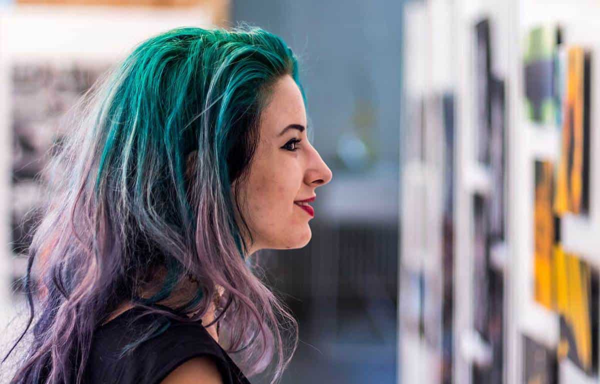 Beautiful young woman with green ombre hair