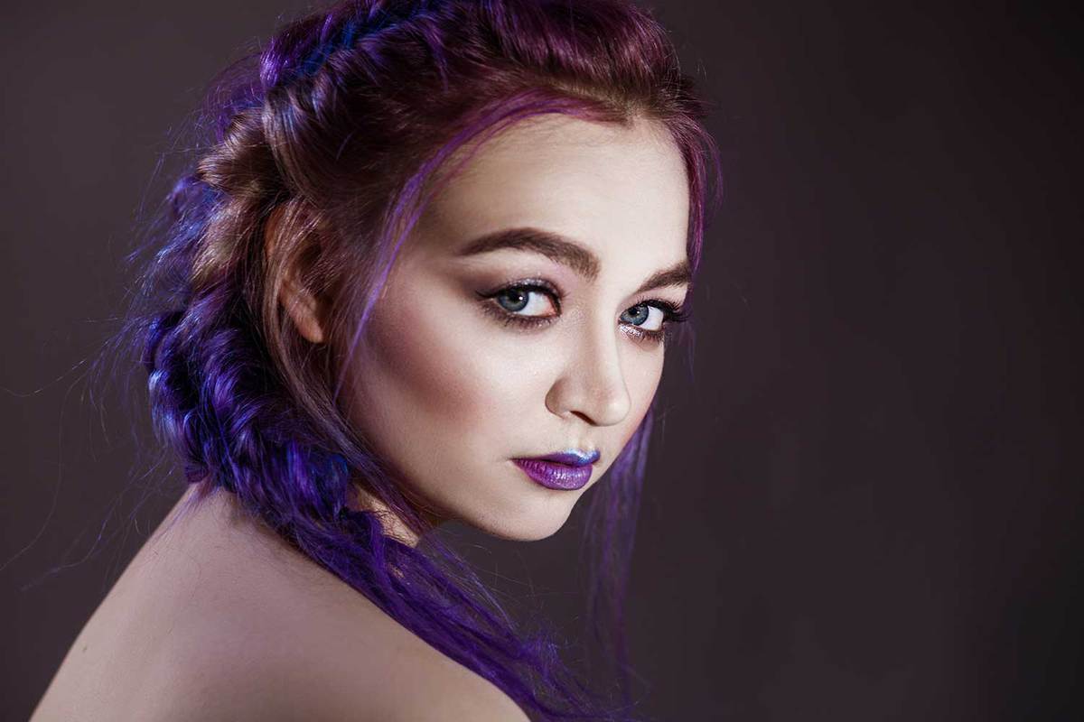 Close-up of a girl with colorful blue hair and make up