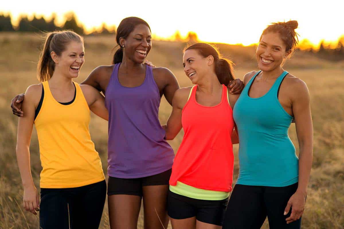 Diverse group of adult female athletes wearing tank tops