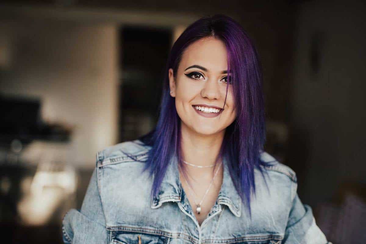 Happy smiling hipster girl with purple hair