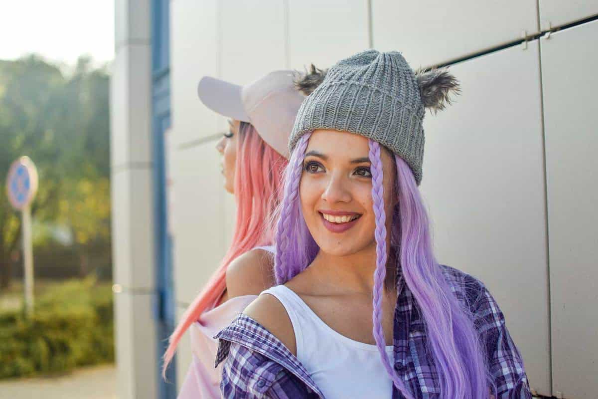 Two young beautiful women with pink and purple hair