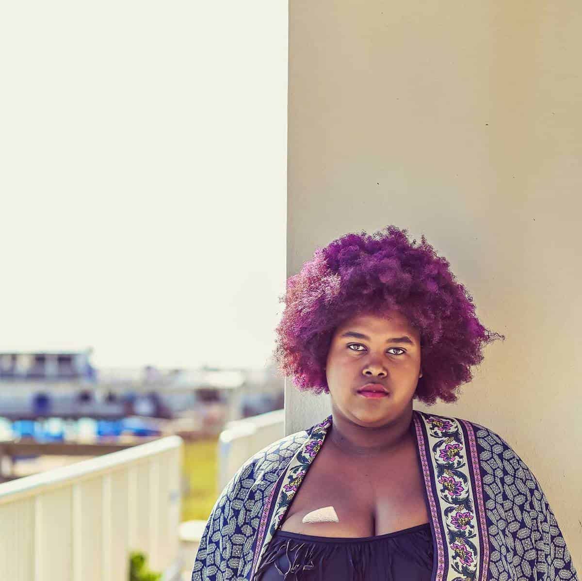 Young pretty african american plus size woman with purple hair