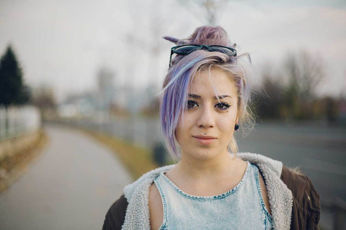 Young woman with colorful hair on the street wearing jacket