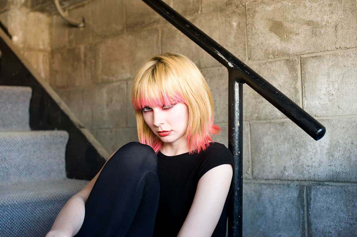 Young woman in a stairwell with a retro punk look