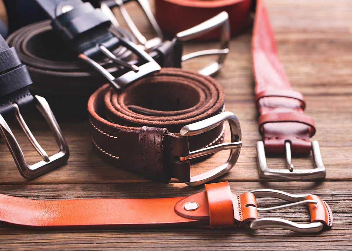Leather colored belts on a wooden table