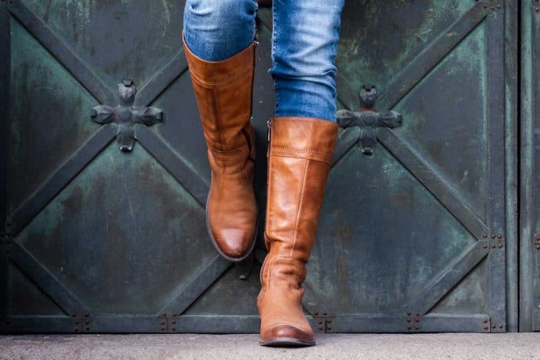 Woman in jeans and brown leather boots leaning on gate, What Are Boots Made Of?