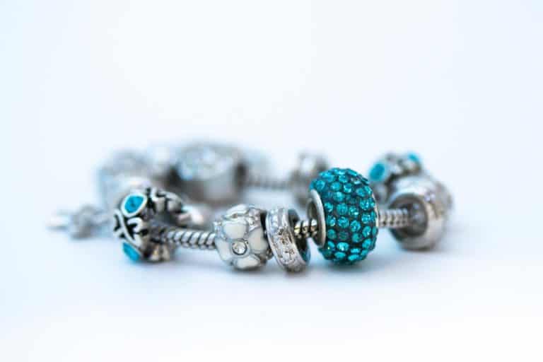 A Pandora bracelet with blue gems attached to the bracelet, My Pandora Bracelet Turned Black - What To Do?