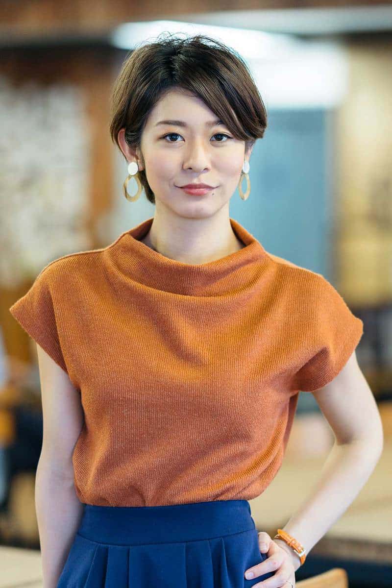 A portrait of a young business woman with short hair in a modern co-working space
