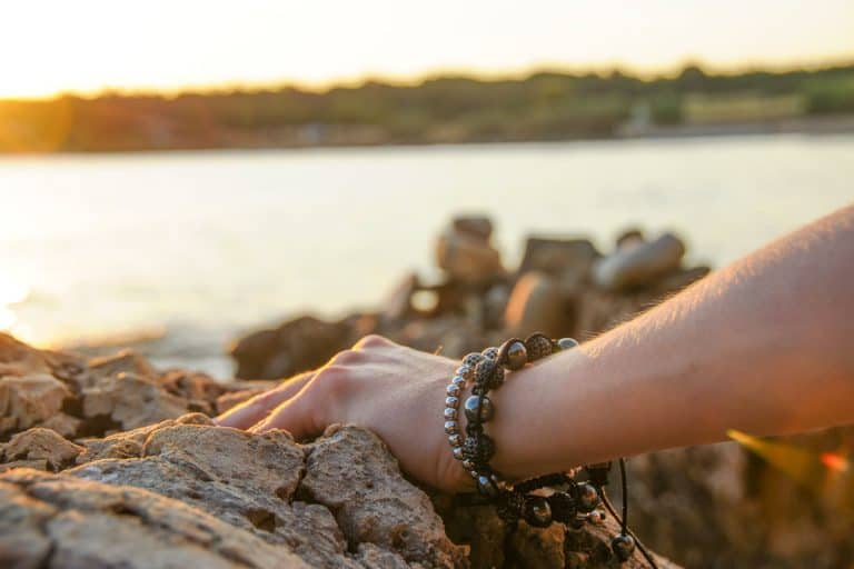 A woman holding a rock exposing her bracelet, Should Bracelets Be Loose?