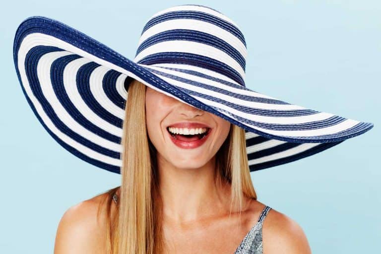 Beautiful blonde woman in striped summer hat smiling, 23 Types Of Hats For Women You Should Know