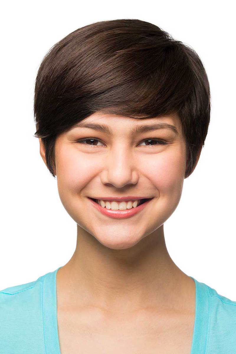 Close-up of Latin American girl with short hair smiling isolated over white background