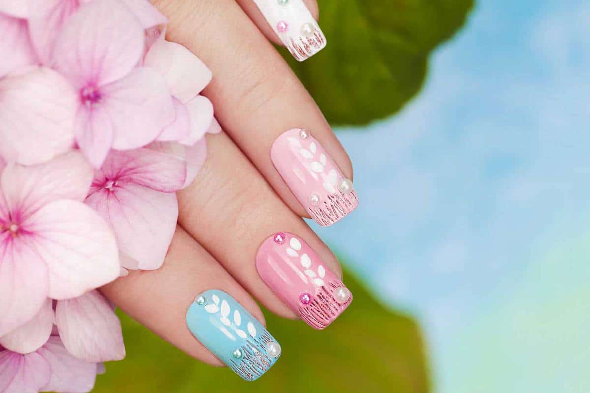 Pastel manicure with rhinestones and sequins on the background of Hydrangeas