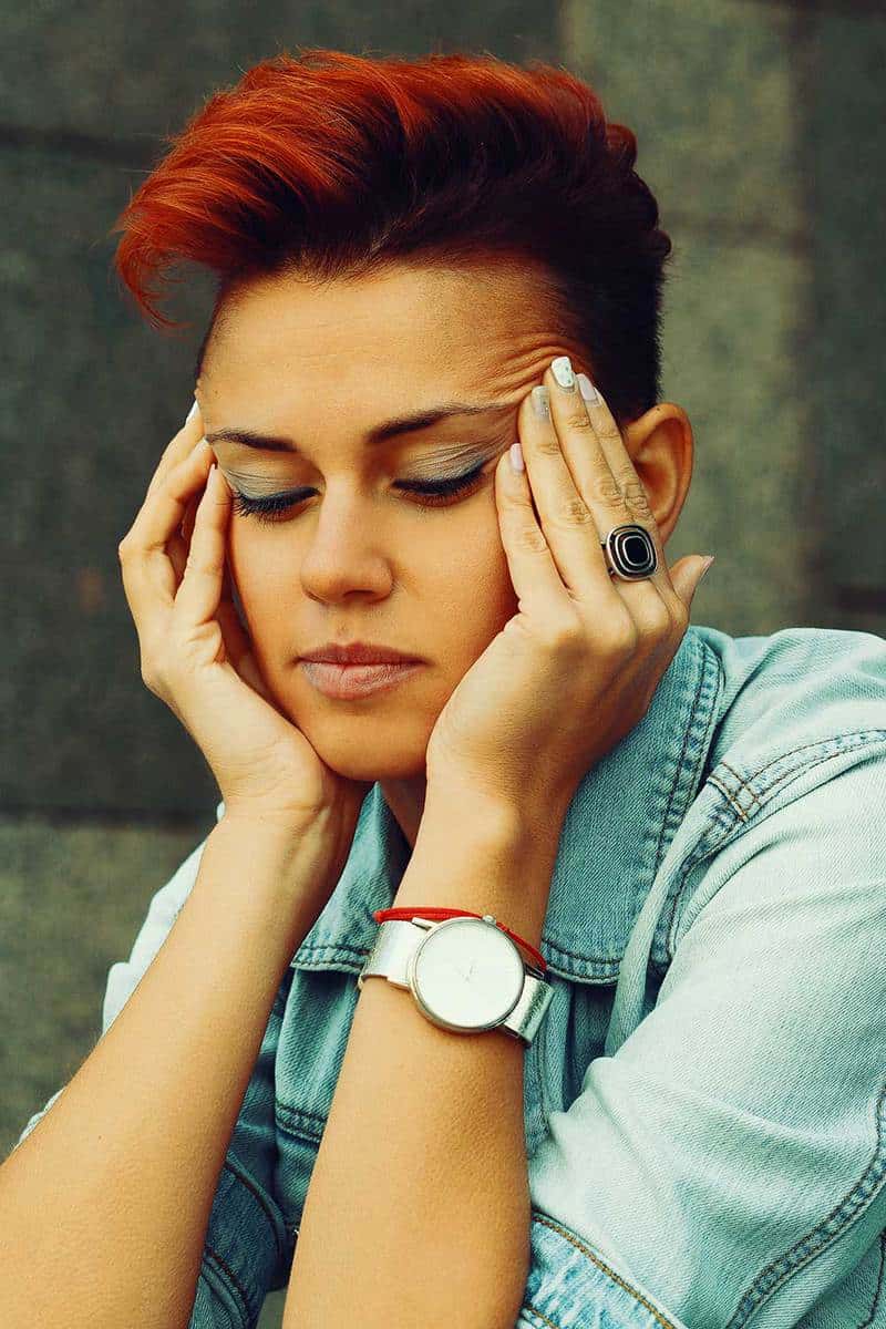Portrait of a depressed woman with short red hair