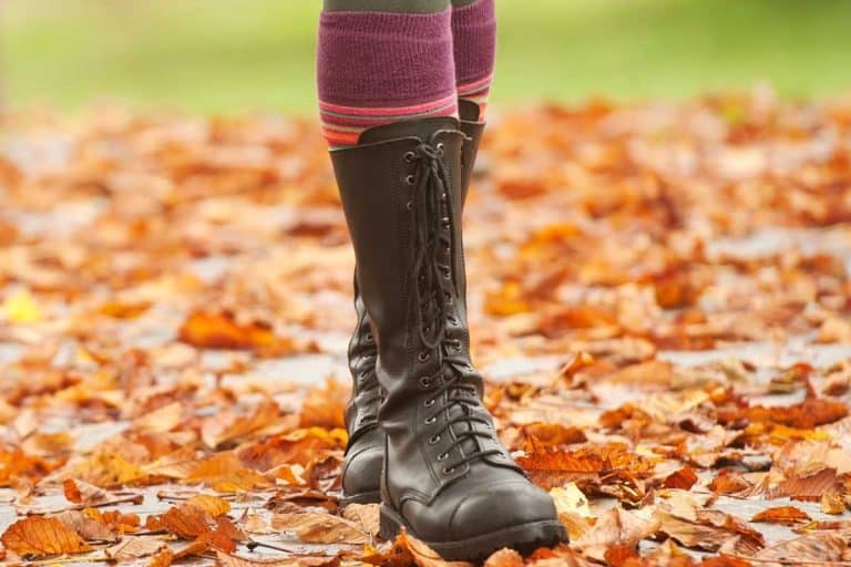 Woman walking in autumn wearing boots with socks, How To Wear Socks With Boots