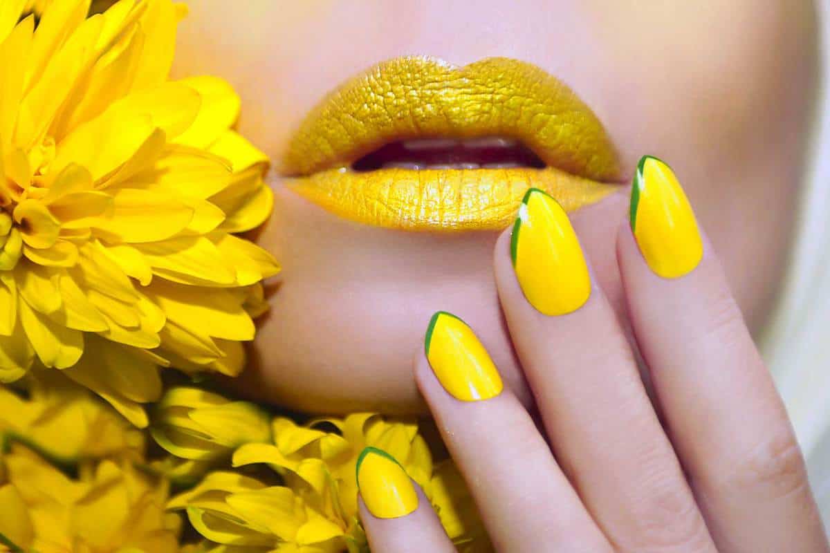 Yellow manicure and makeup on a woman with flowers