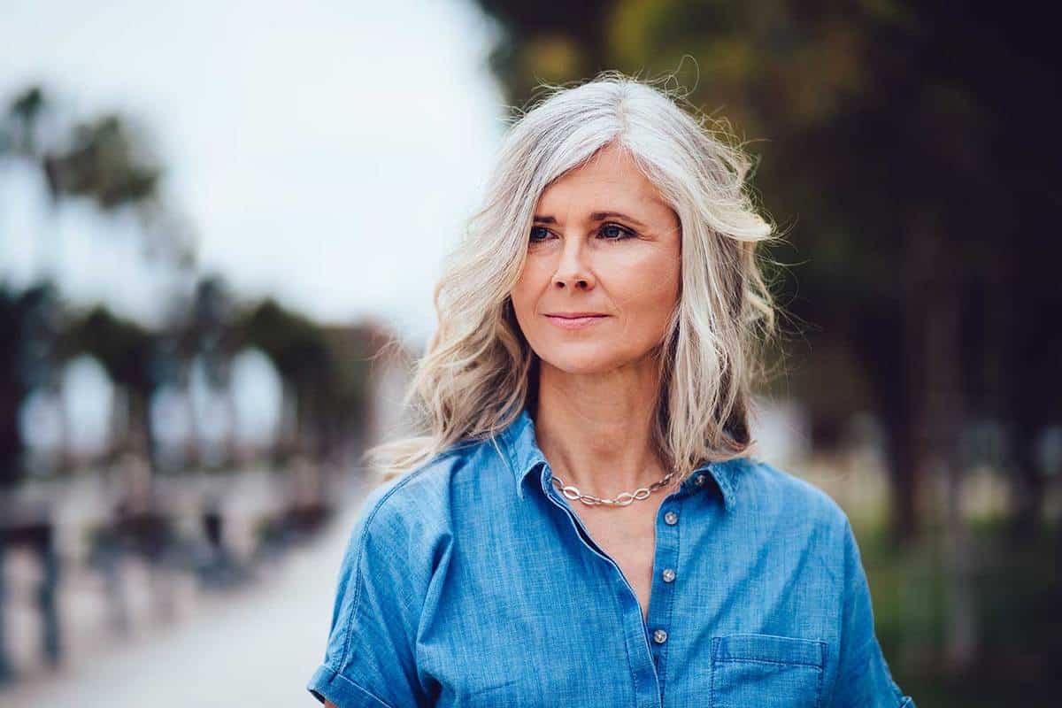 Beautiful fashionable mature woman with gray hair in the city street