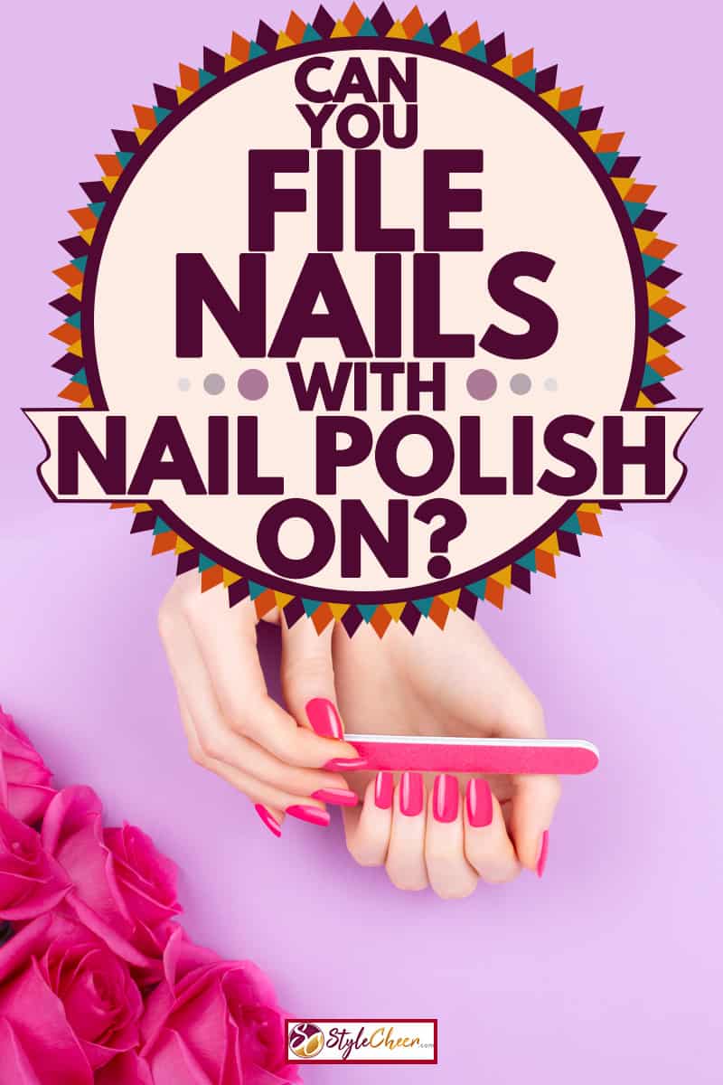 A woman filing her nails with a pink colored nail filer, Can You File Nails With Nail Polish On?
