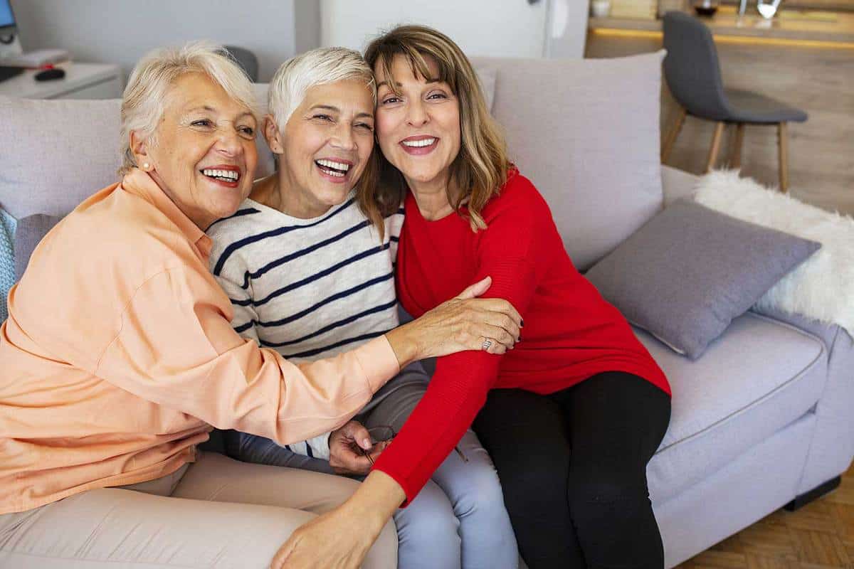 Happy senior women smiling and hugging at home