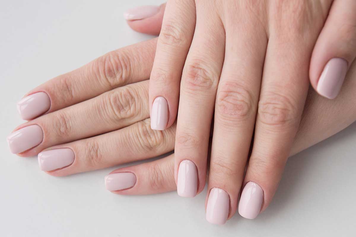 Manicured nails with beige dipping powder.
