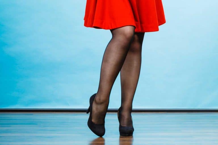 Woman wearing red dress, dark tights and black high heels, Should I Wear Tights with a Dress? [Here's How]