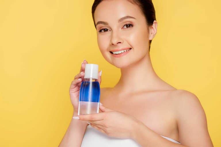 Beautiful woman holding micellar water in bottle, Can You Use Micellar Water Instead Of Cleanser?