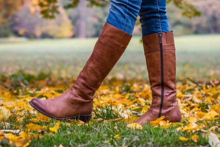 Woman wearing brown leather boots and walking in fallen leaves, Is Your Boot Size the Same as Your Shoe Size?