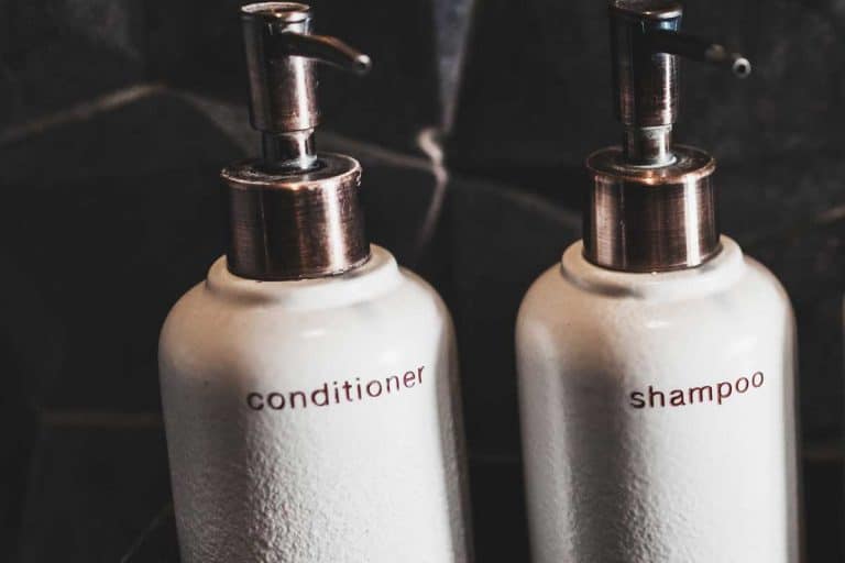 White metal bottles of shampoo and conditioner on wooden shelf, Is It Good To Mix Shampoo With Conditioner?