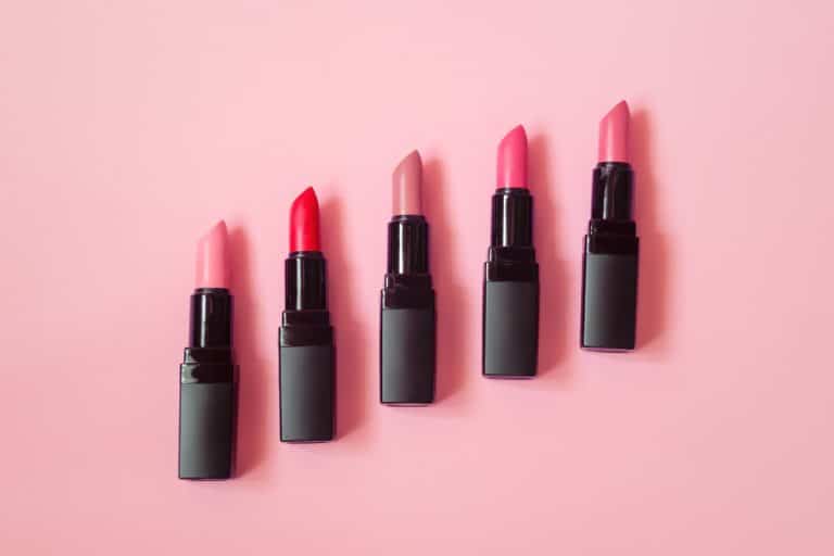 Women's lipstick on a pink background, Should You Wear Lipstick to an Interview? [and What Color to Choose]