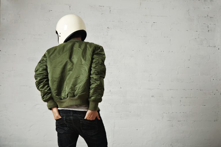 Green bomber jacket worn by a moto biker, How Long Should A Bomber Jacket Be?