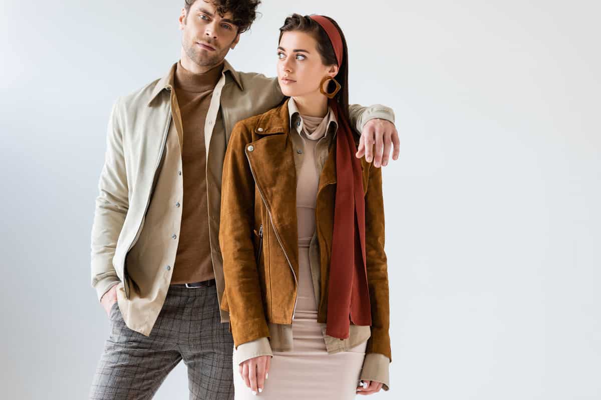 A couple wearing leather jackets and scarf