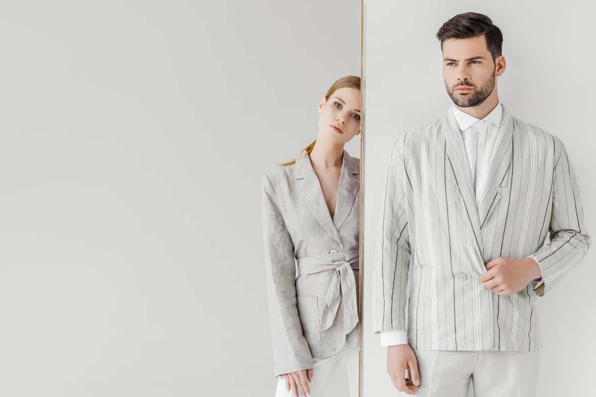 Formally dressed couple wearing stripped tuxedos and light gray color jeans