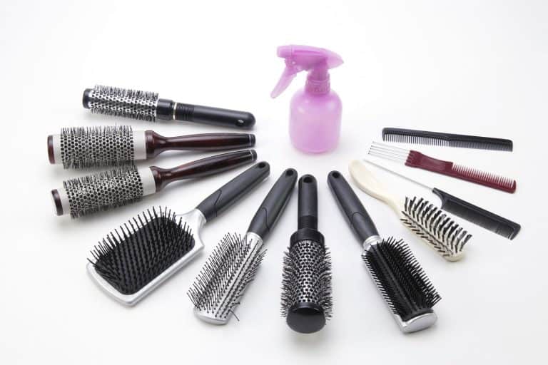 A spray bottle and spread of brushes. A great picture for cosmotology themed designs