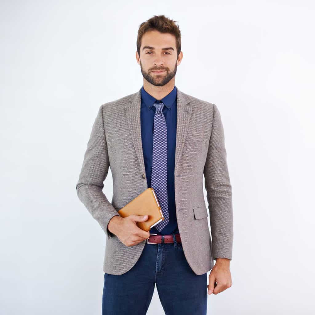 A stylish businessman holding a planner