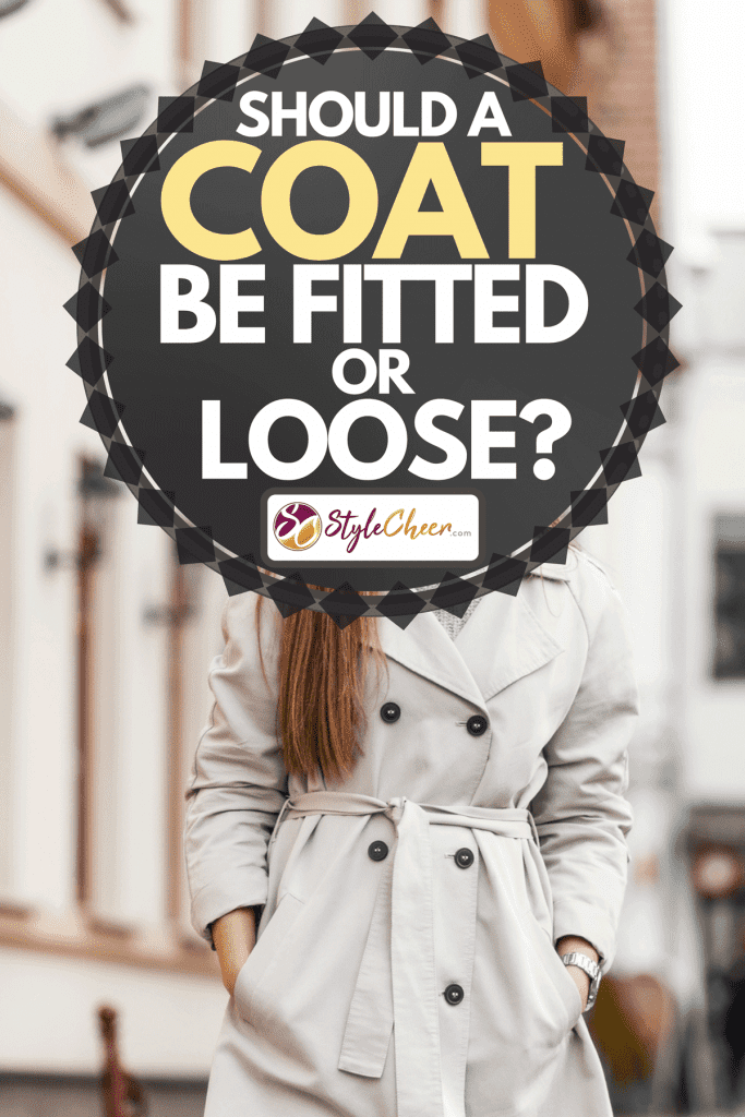 A charming young woman with brown hair in elegant stylish trench coat, Should a Coat Be Fitted or Loose?