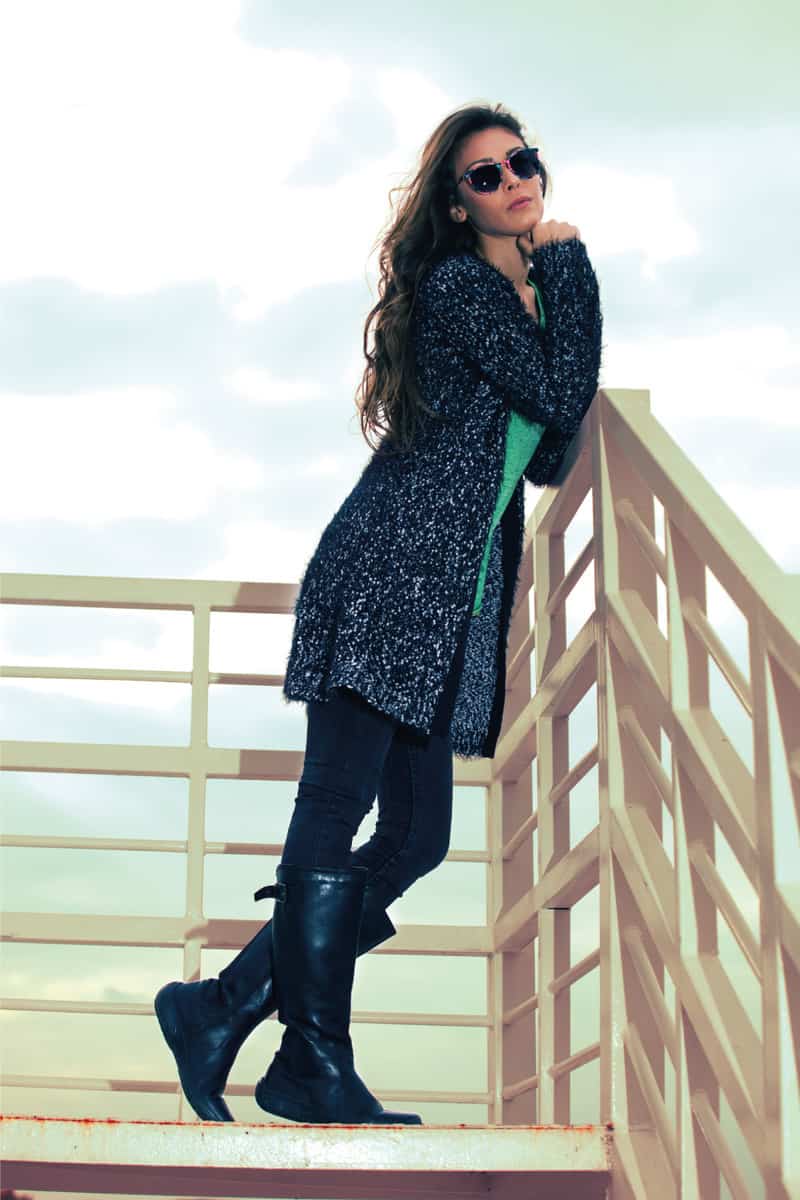 womain in winter fashion wearing shearling boots knee length on a elevated walk way