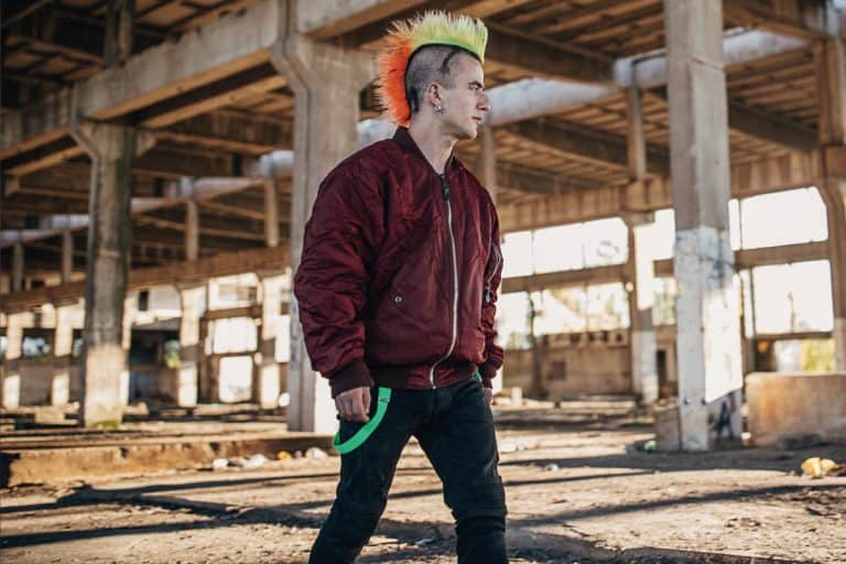 Young male punker with colorful coiffure and red bomber jacket walking in abandoned warehouse, How Much Does A Bomber Jacket Weigh?