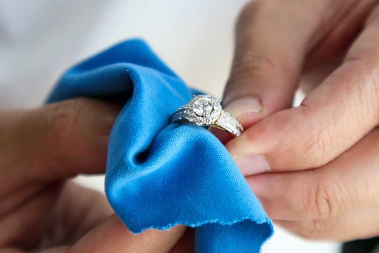 Jeweller hand polishing and cleaning jewelry diamond ring with micro fiber fabric, 4 Best Engagement Ring Cleaners