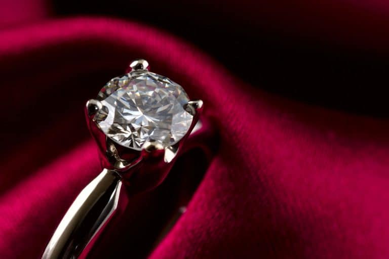 Macro shot of an engagement solitaire diamond ring. Burgundy silk background, Do Engagement Rings Have To Be Diamond?