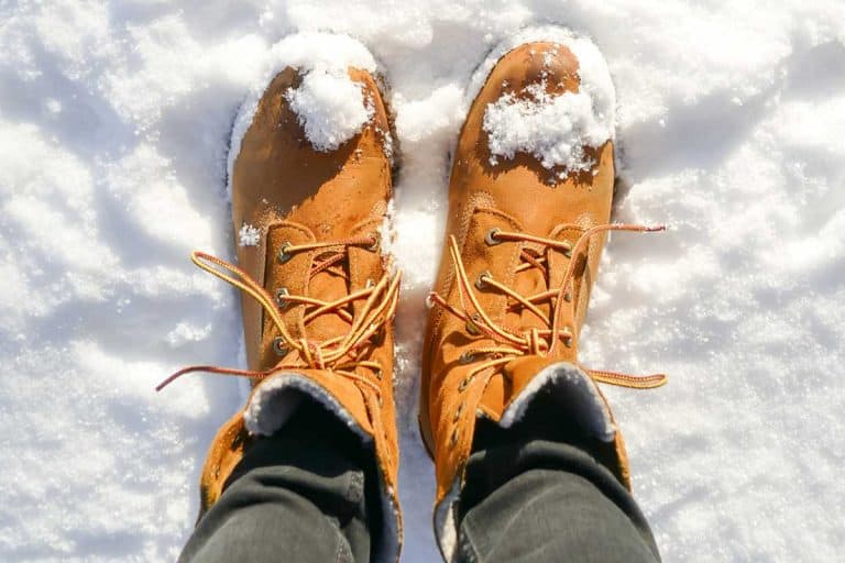 Top view of brown leather boots in fresh snow, What Shoes to Wear in Snow?