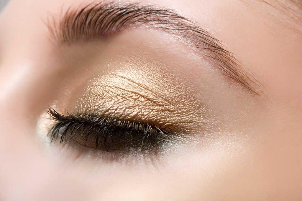 Woman wearing gold eye shadow