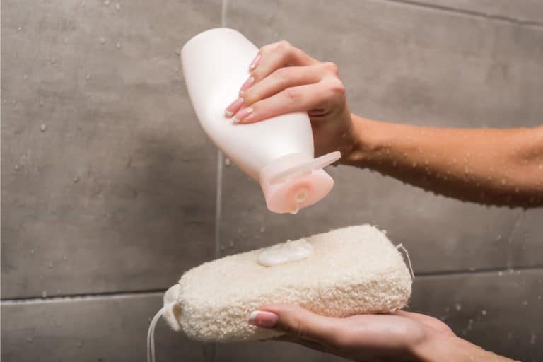 Girl applying shower gel to a body scrubber, Can Shower Gel Be Used As Shampoo?