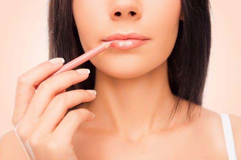A woman putting on a pink colored lip liner, What Can I Use Instead Of Lip Liner? [9 Lip Liner Alternatives]