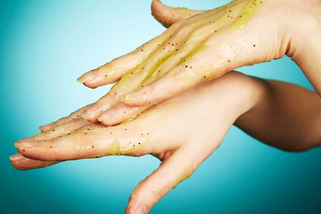 A woman putting body cleanser on hands