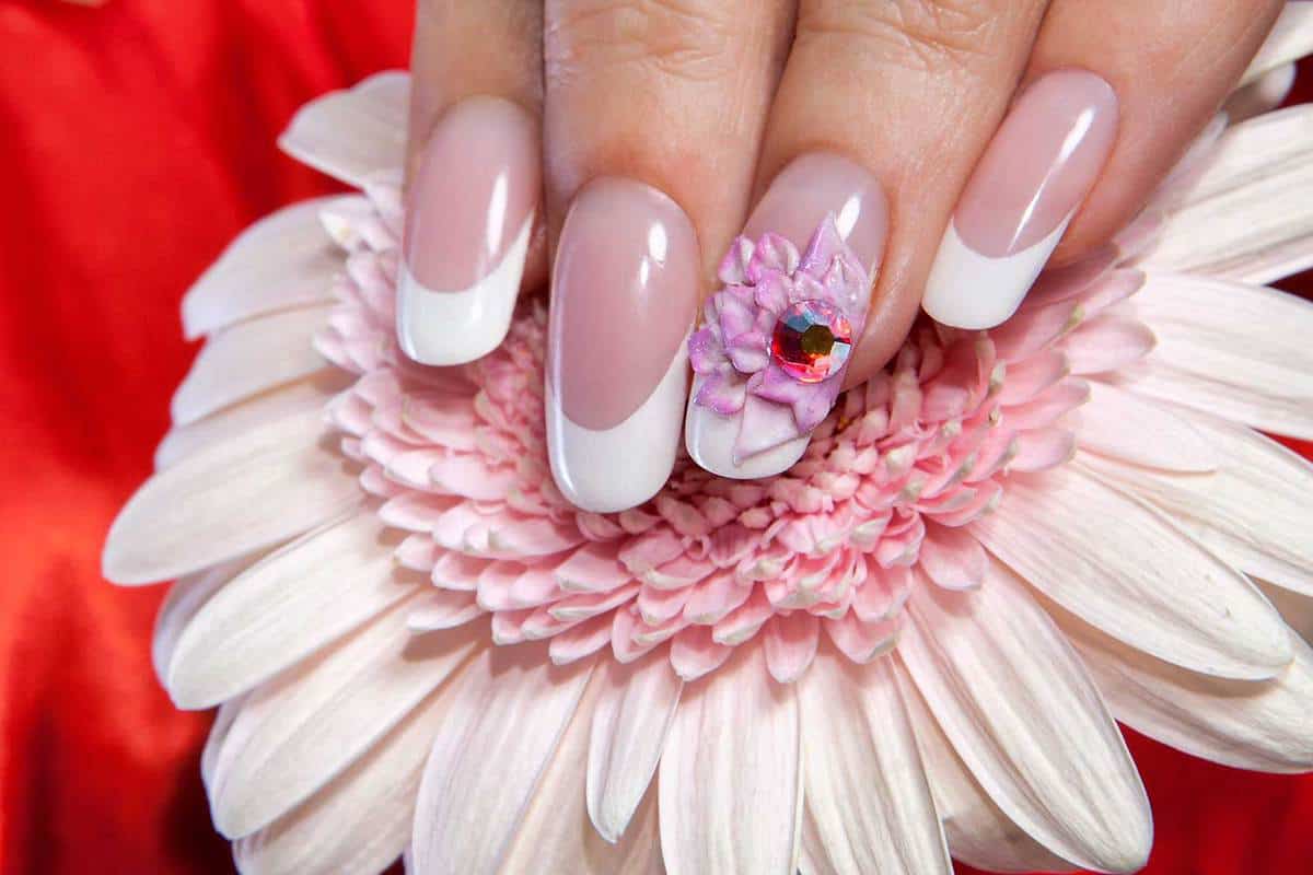 Beautiful manicured nails on a flower