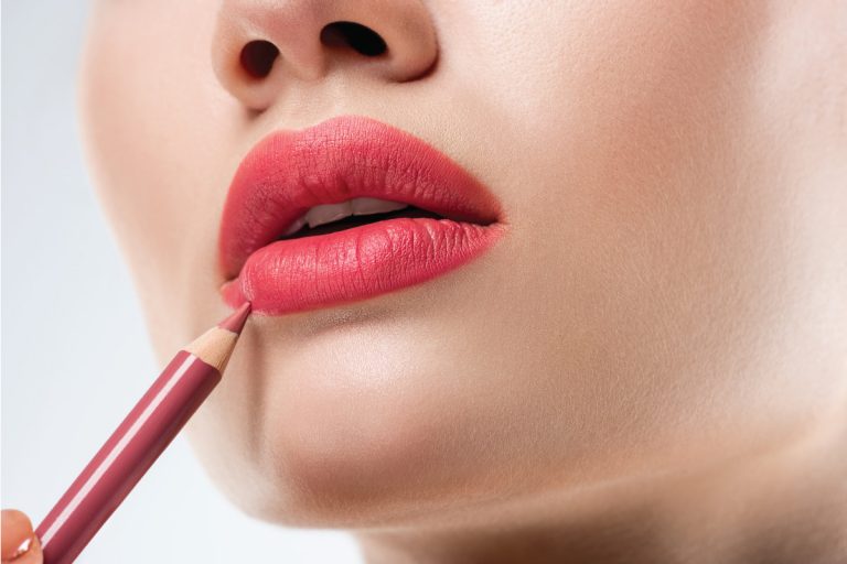 Close up studio shot of woman applying lip pencil. How To Sharpen Plastic Lip Liner