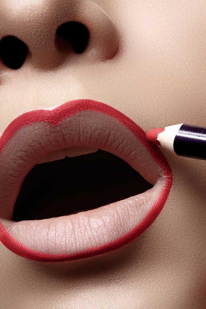 Close up of woman plump lips with lip liner