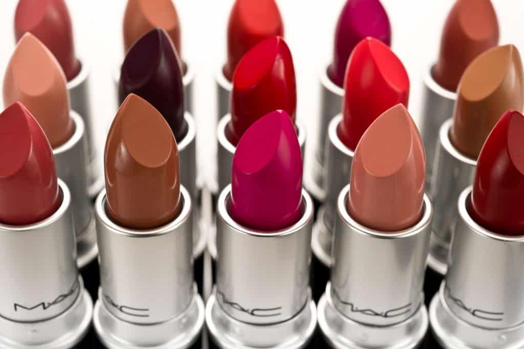 Different colors and shades of lipsticks on a white background