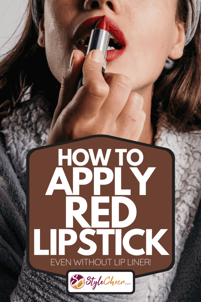 Beautiful woman applying a red lipstick in studio, How To Apply Red Lipstick [Even Without Lip Liner!]