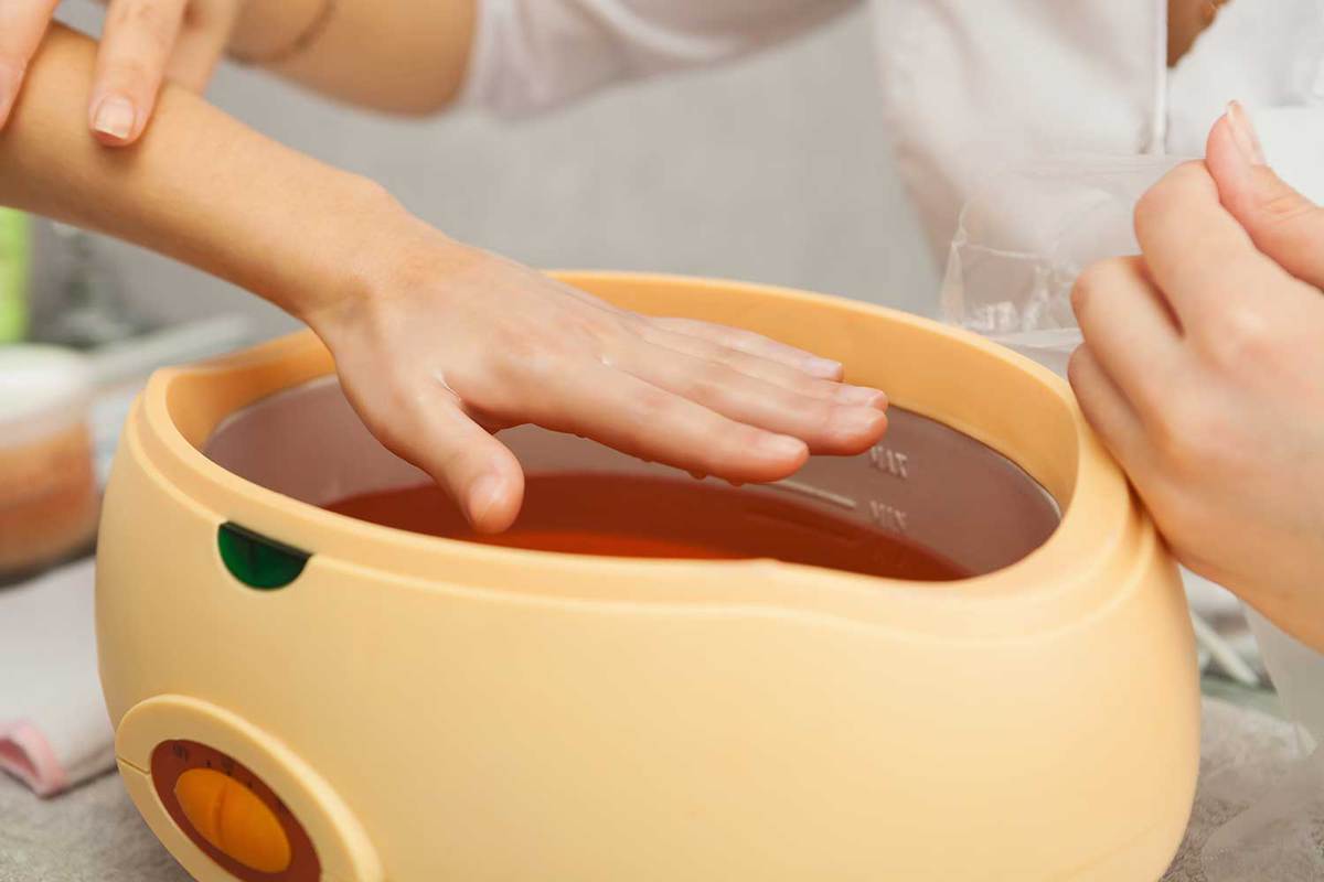 Paraffin hand bath in a spa salon